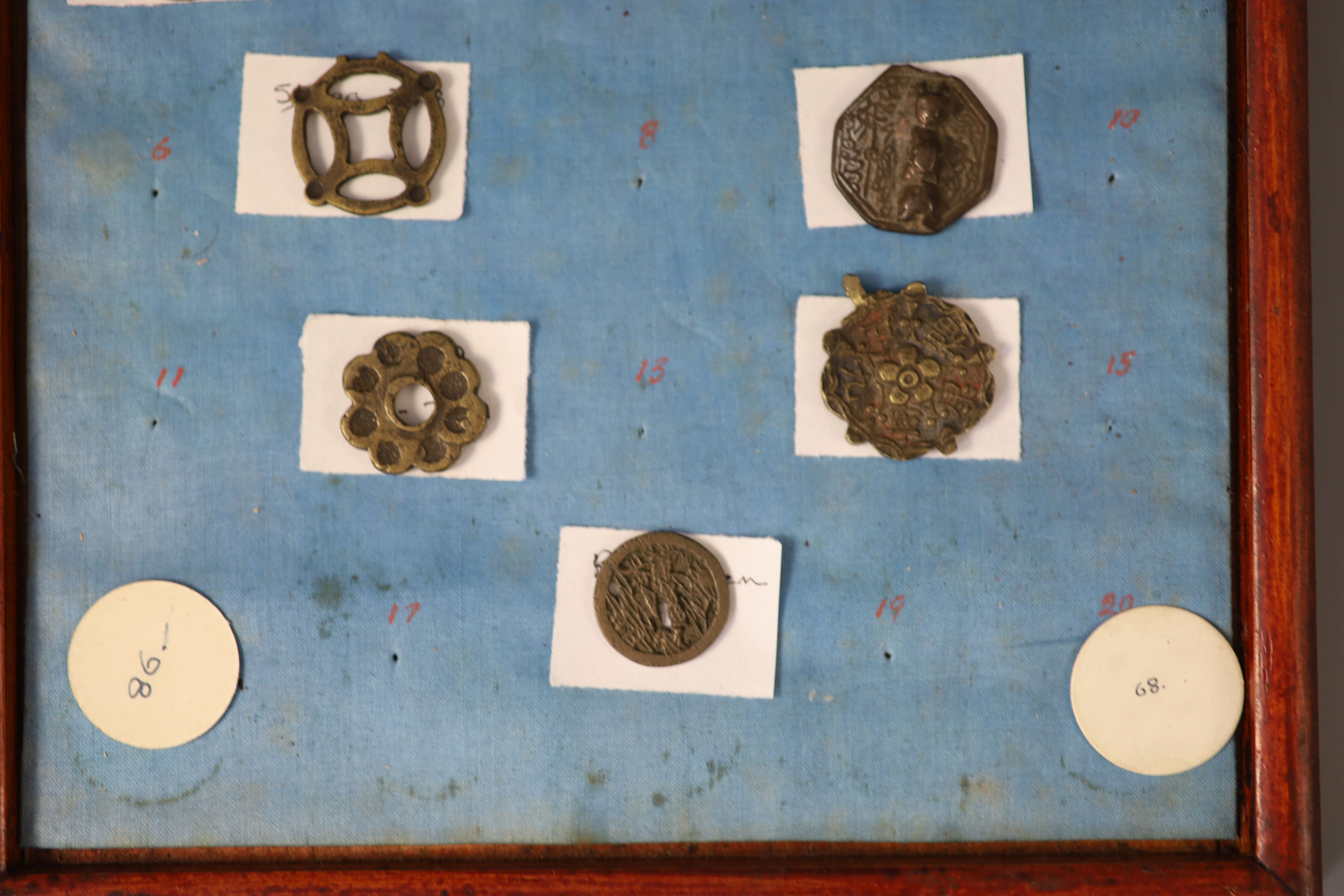 A group of 99 Korean bronze and metal amulets or charms, 19th/20th century